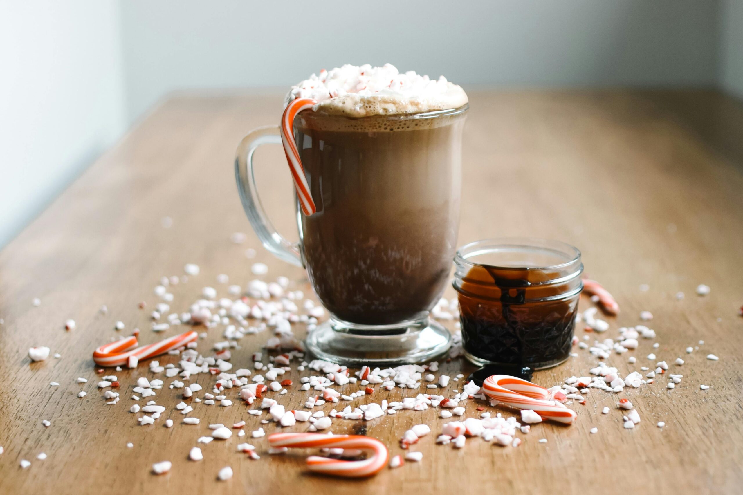 Delicious hot chocolate with whipped cream and candy cane, perfect for holiday treats.
